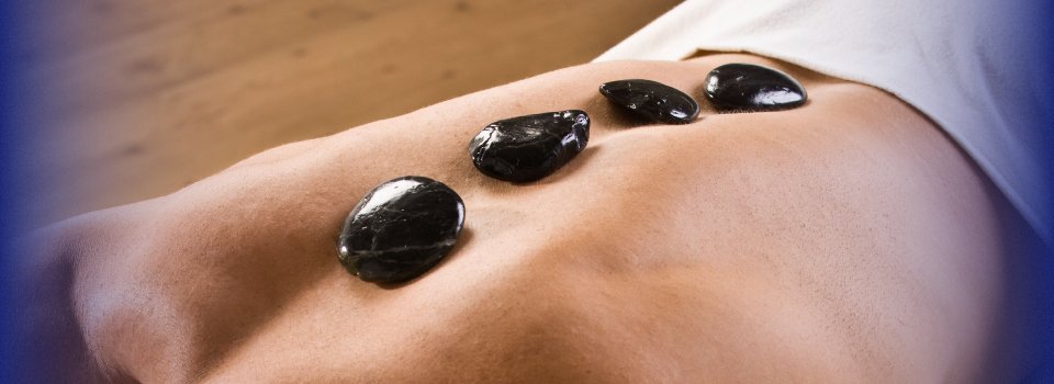 Man receiving hot stone massage therapy